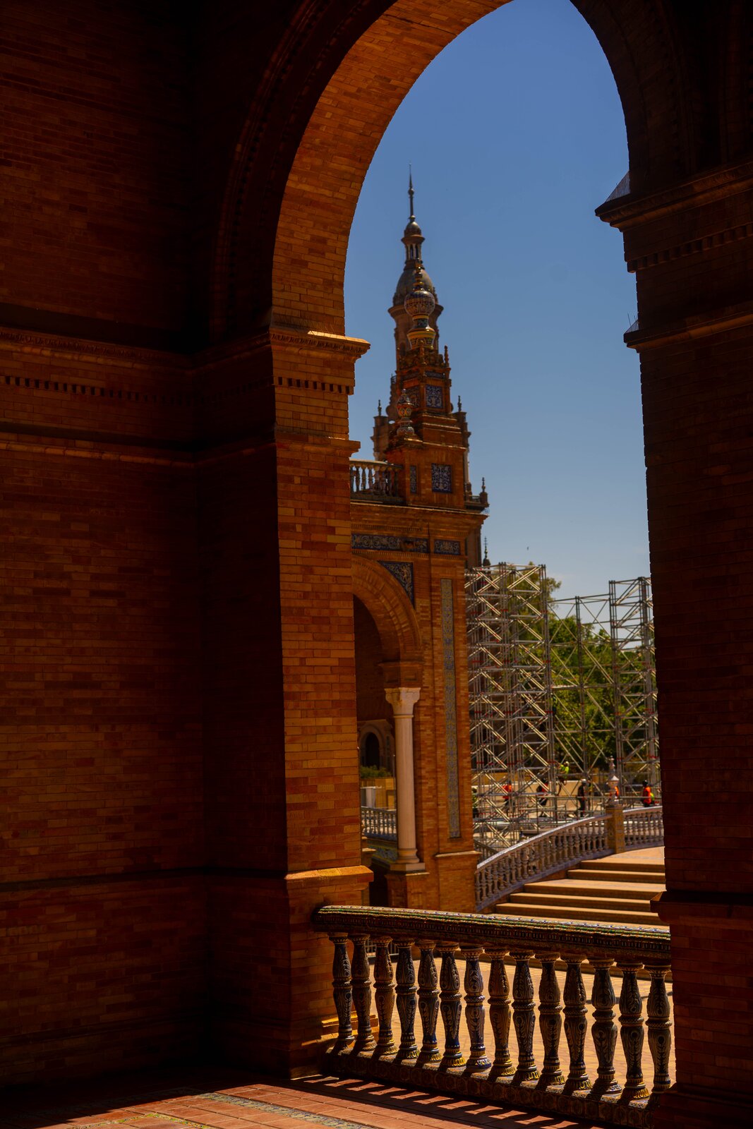 A brick archway framing the Plaza de España tower