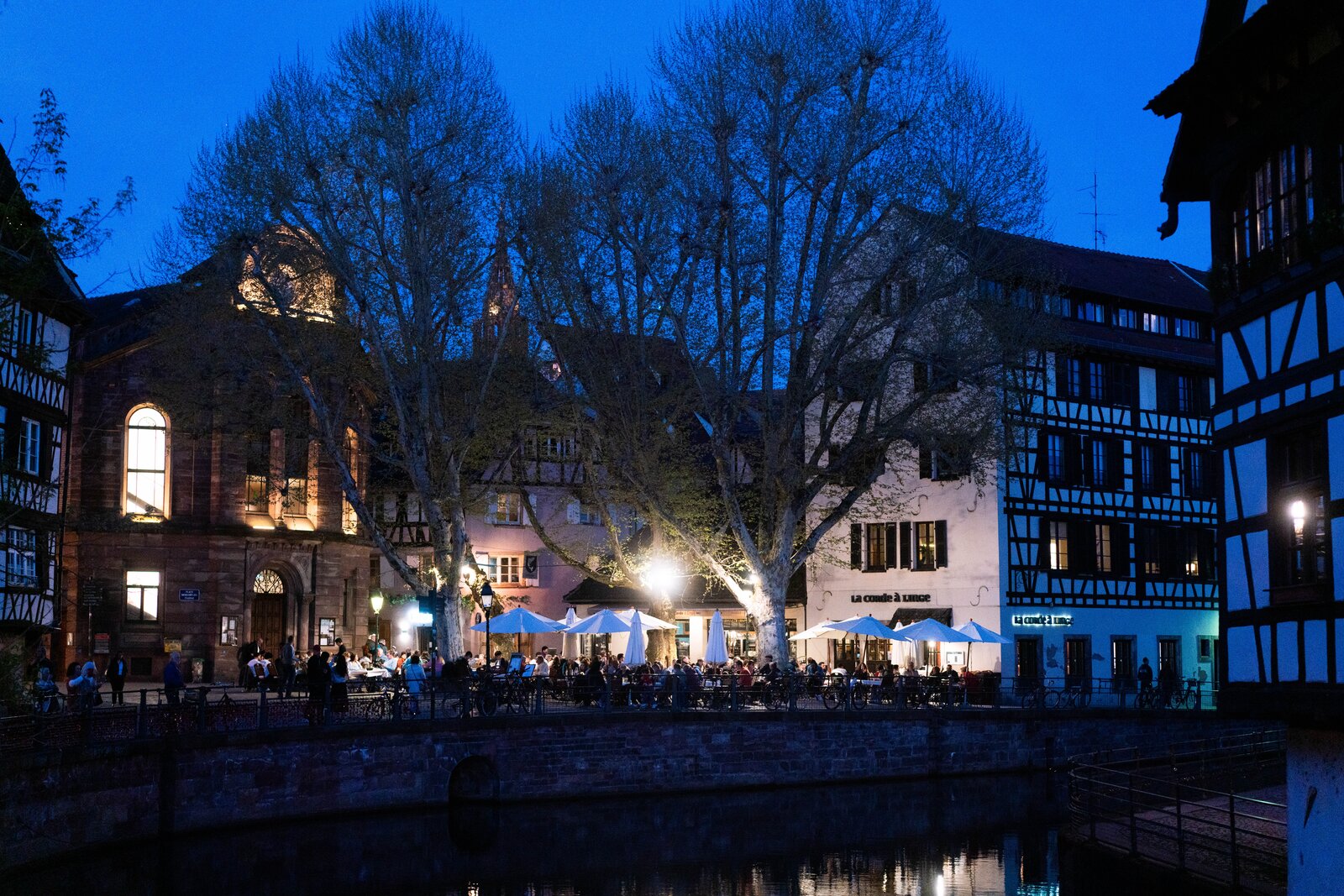 Petite France at blue hour with a tourist boat